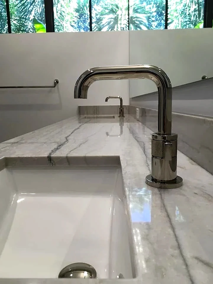Polished nickel bathroom faucet on a marble vanity, South Florida