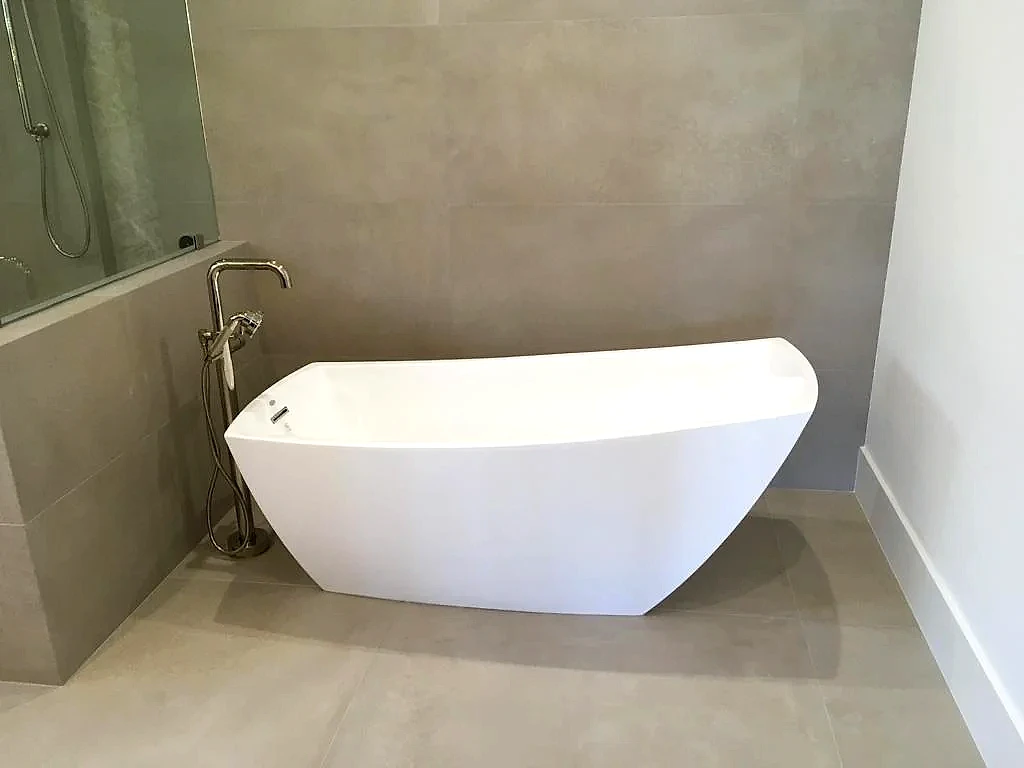 Freestanding tub with floor-mounted tub filler installed, Florida bathroom