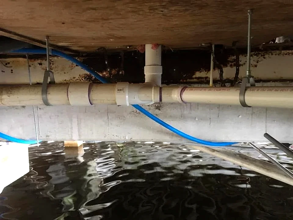 Main drain pipe replaced and strapped under a raised home, South Florida